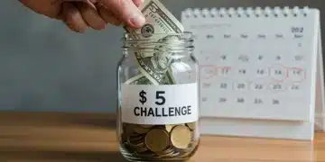 Hand putting $5 bill into savings jar for challenge